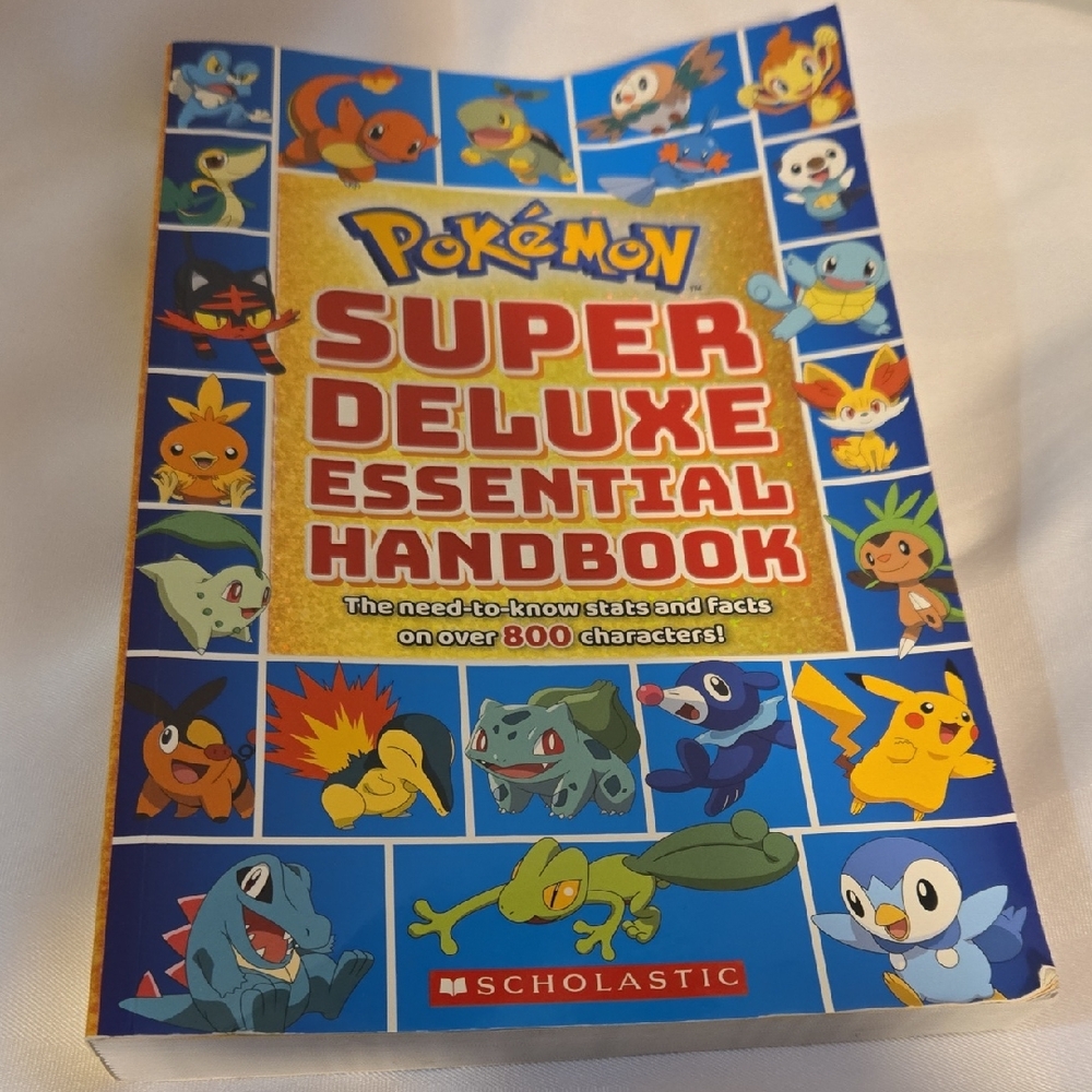 Scholastic Pokémon Super Deluxe Essential Handbook - Blue & Gold Cover